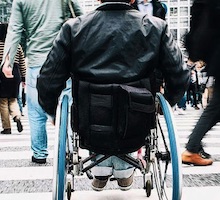 Man on wheelchair in crowd