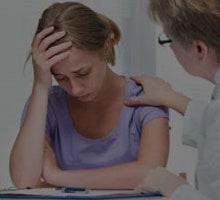 Doctor talking to distressed woman