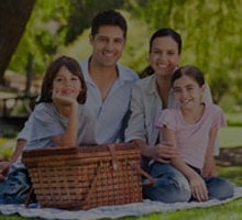 Man and woman with two kids on picnic